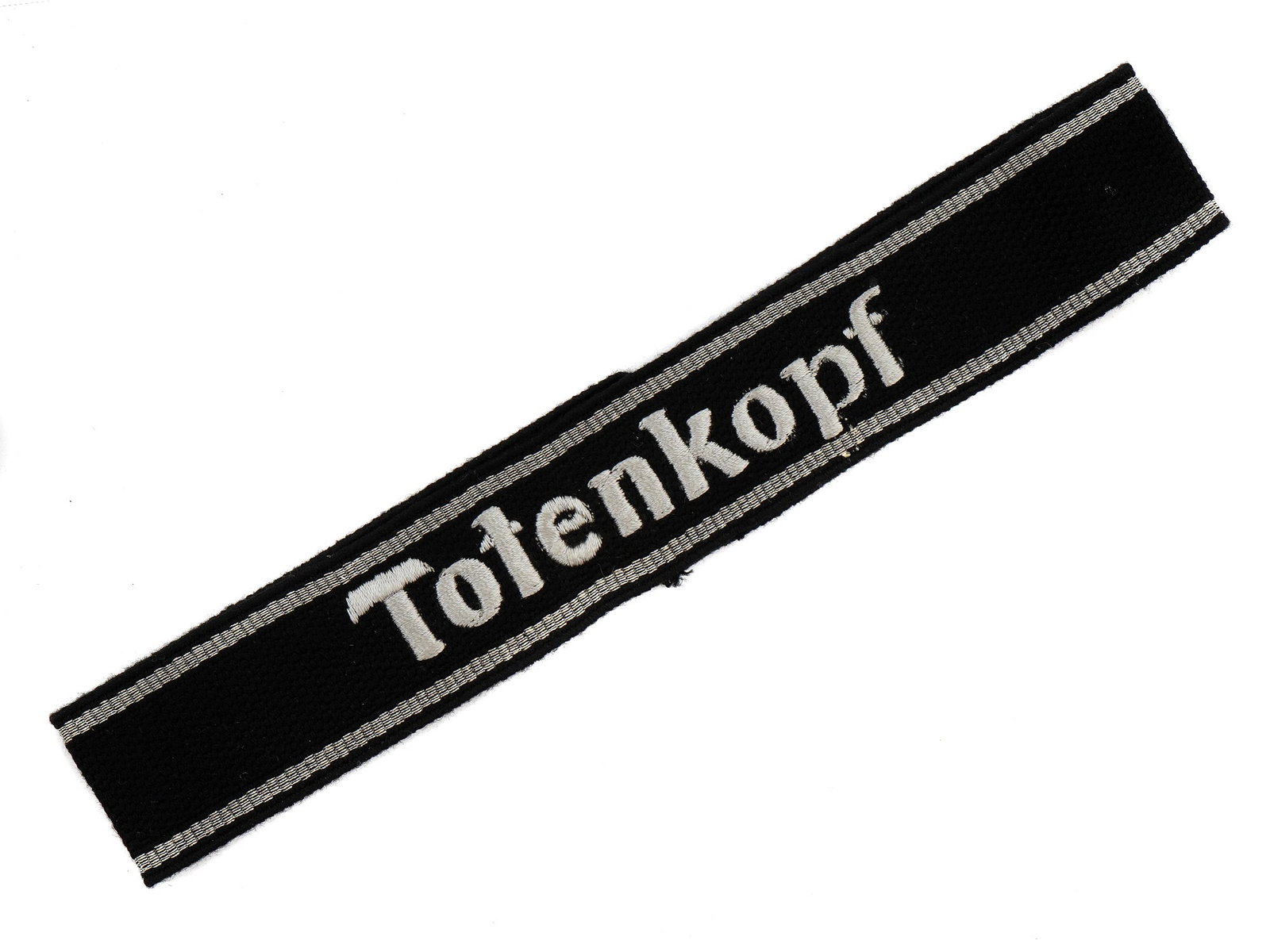 A GERMAN WW2 THIRD SS PANZER DIVISION 'TOTENKOPF' CUFFTITLE: A Nazi German 'Totenkopf' cufftitle of the 3rd SS Panzer Division in very good condition. This example retains its RZM tag. L: 18 in., (45.72 cm.)