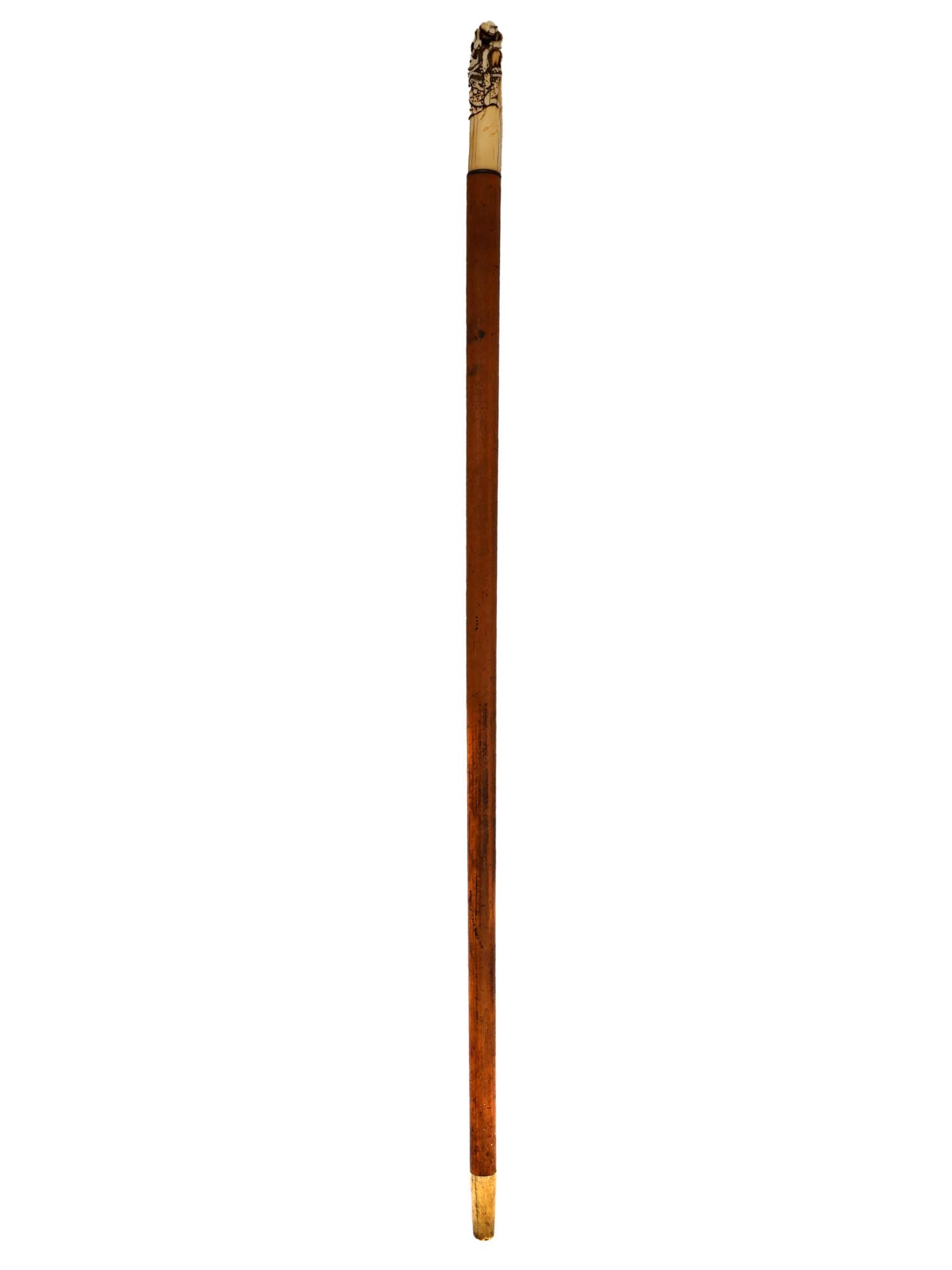 A WALKING CANE WITH CARVED HANDLE, CHINA, 19TH CEN.: Late 19th-century Chinese carved-handle walking cane. The shaft is round with a metal tip. Ca. 1900. L: 35 in., (89 cm.)