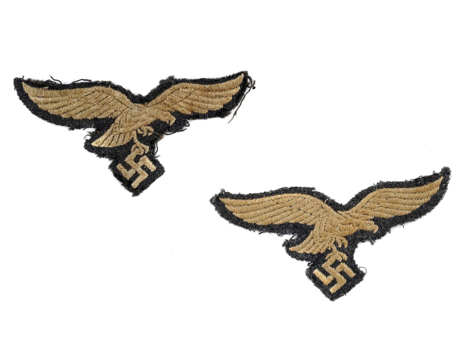 TWO GERMAN WWII EAGLE PATCHES FOR THE LUFTWAFFE TUNIC: Two cloth patches of Luftwaffe eagle for enlisted men. Germany - WWII L: 3 1/2 in., (9 cm.)