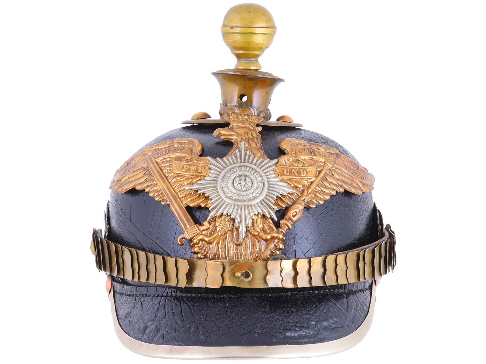 A PRUSSIAN WWI GUARD INFANTRY PICKELHAUBE HELMET: World War I-era German "Pickelhaube", constructed of lacquered black leather, with a brass circular plate at the crown bearing four rivets, topped with a 3 1/2" brass spike. The front bears a brass "w