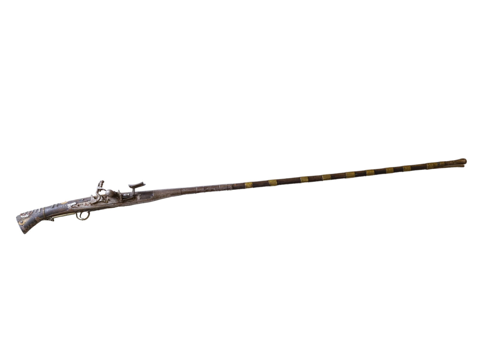 A TUNISIAN FLINTLOCK MOUKAHLA IN SILVER MOUNTS, 19TH CENTURY: A decorated smoothbore Tunisian Moukahla of about .75 caliber, with brass mounting along the length of the stock. The stock is bone-inlaid. Provenance: private collection, France. L: 59 in., (150 cm.)