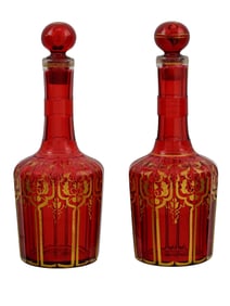 A PAIR OF GILT-RUBY GLASS LIDDED DECANTERS, CA. 1850