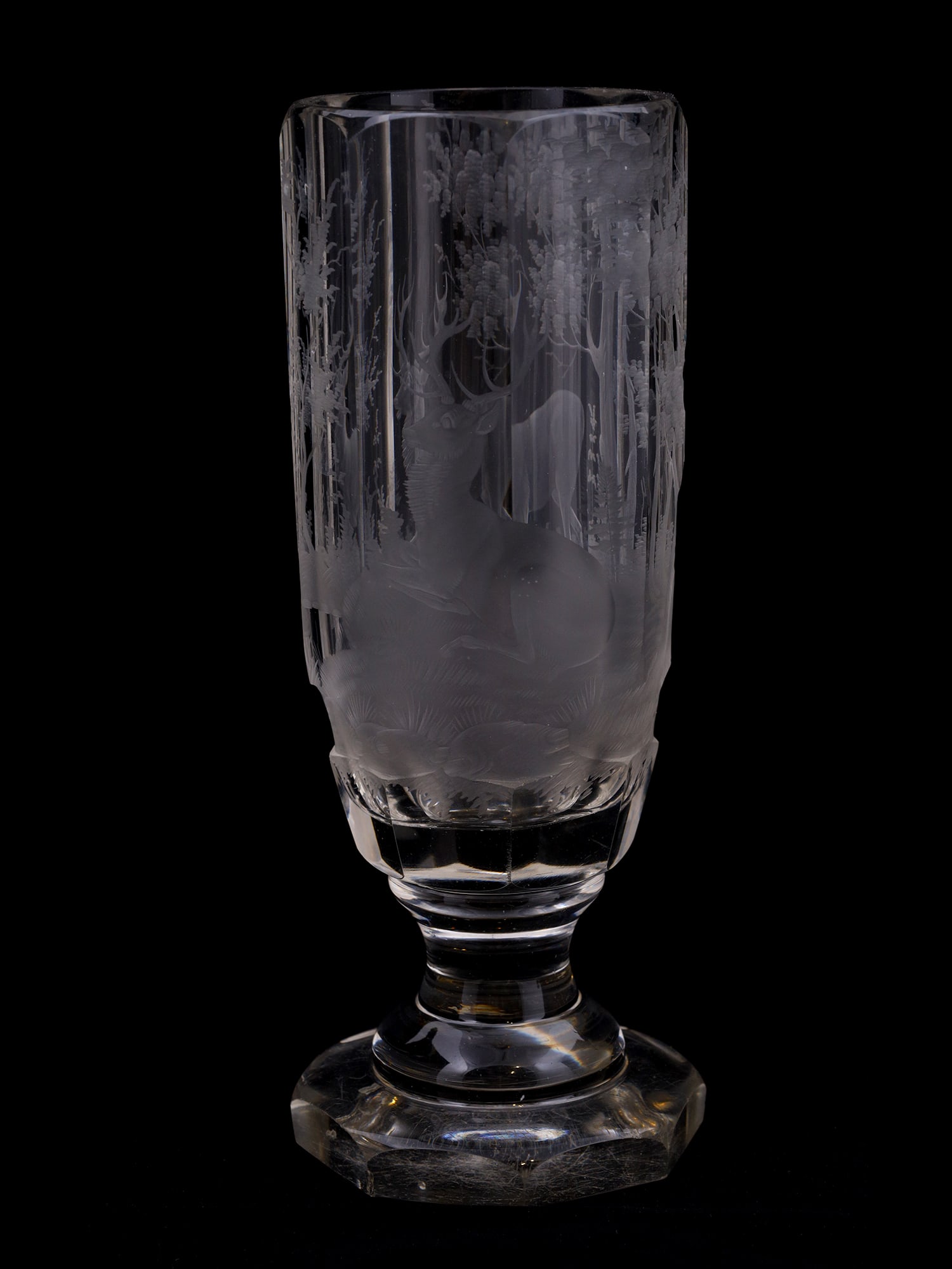 AN ENGRAVED BOHEMIAN FACETED 'SPA' GLASS BEAKER, CA. 1880: Probably of the Bohemian origin a finely engraved wine glass or goblet that depicts forest deers. The form of the glass is faceted which is a typical design of the 19th century. There are no chips or