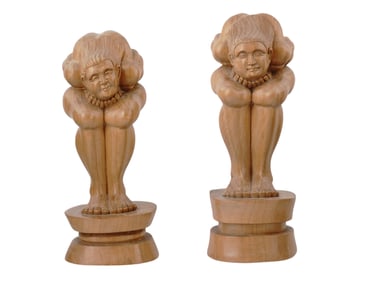 A PAIR OF CARVED WOODEN YOGIS WITH THEIR HEADS IN THEIR LAPS