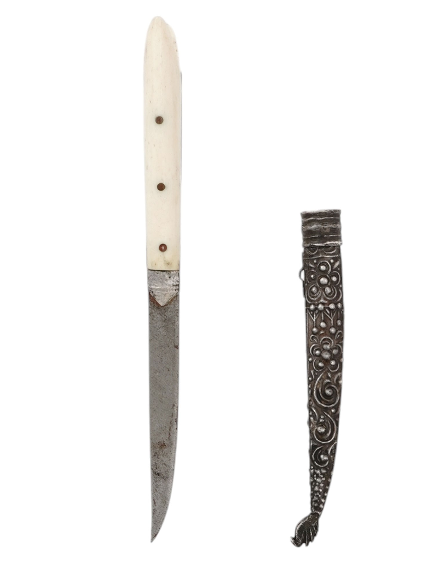 AN OTTOMAN GREEK CRETE SILVER-MOUNTED BICHAQ DAGGER, 19TH C.: An Ottoman Cretan Greek bichaq style knife with a characteristically shaped blade kept within a silver sheath with embossed and incised floral decoration. The hilt is comprised of two bone grip scales