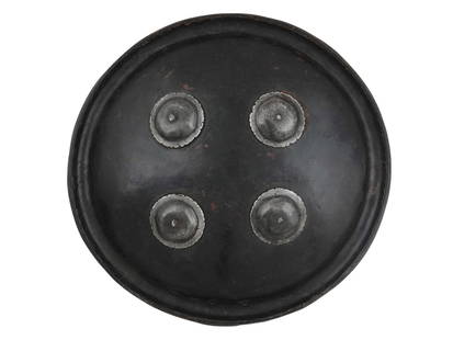 A 19TH C. INDO-PERSIAN DHAL SHIELD WITH IRON DOMES: An Indian dhal shield made with lacquered hide leather and wrought iron domes. This small military shield, most probably of the mid of the 19th century, was probably made for ceremonial use. The metal