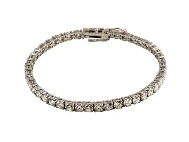 A WHITE 14 K. GOLD 11 K. GSI1 DIAMOND-SET BRACELET
