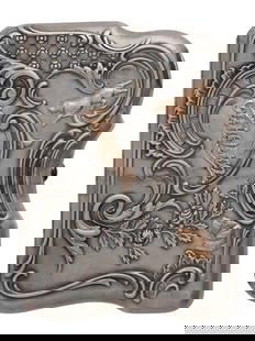 A RUSSIAN SILVER AND GOLD-CASED CIGARETTE CASE BY A. DUBROVIN, CA. 1910: Shaped rectangular form with rounded corners, the exterior elaborately decorated in high relief with scrolling acanthus leaves, flowers, and lattice motifs, highlighted with applied gold accents inclu
