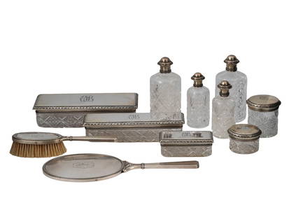 A LOT OF ELEVEN CUT CRYSTAL AND SILVER-MOUNTED TOILET PIECES BY K. FABERGÉ, MOSCOW, EARLY 20TH: Comprising eleven matching dressing table articles, including: a hand mirror, two hairbrushes, four various-sized cut crystal jars with silver mounts and lids, four cut crystal scent bottles with silv