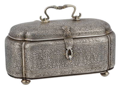 AN INDIAN OR ANGLO-INDIAN CASKET, FROM THE LATE 19TH CENTURY: A rectangular domed casket on four fluted feet, with rounded corners and a hinged lid. Made of silvered bronze, with repoussé and chased floral arabesques typical of Indian craftsmanship, possibly fr