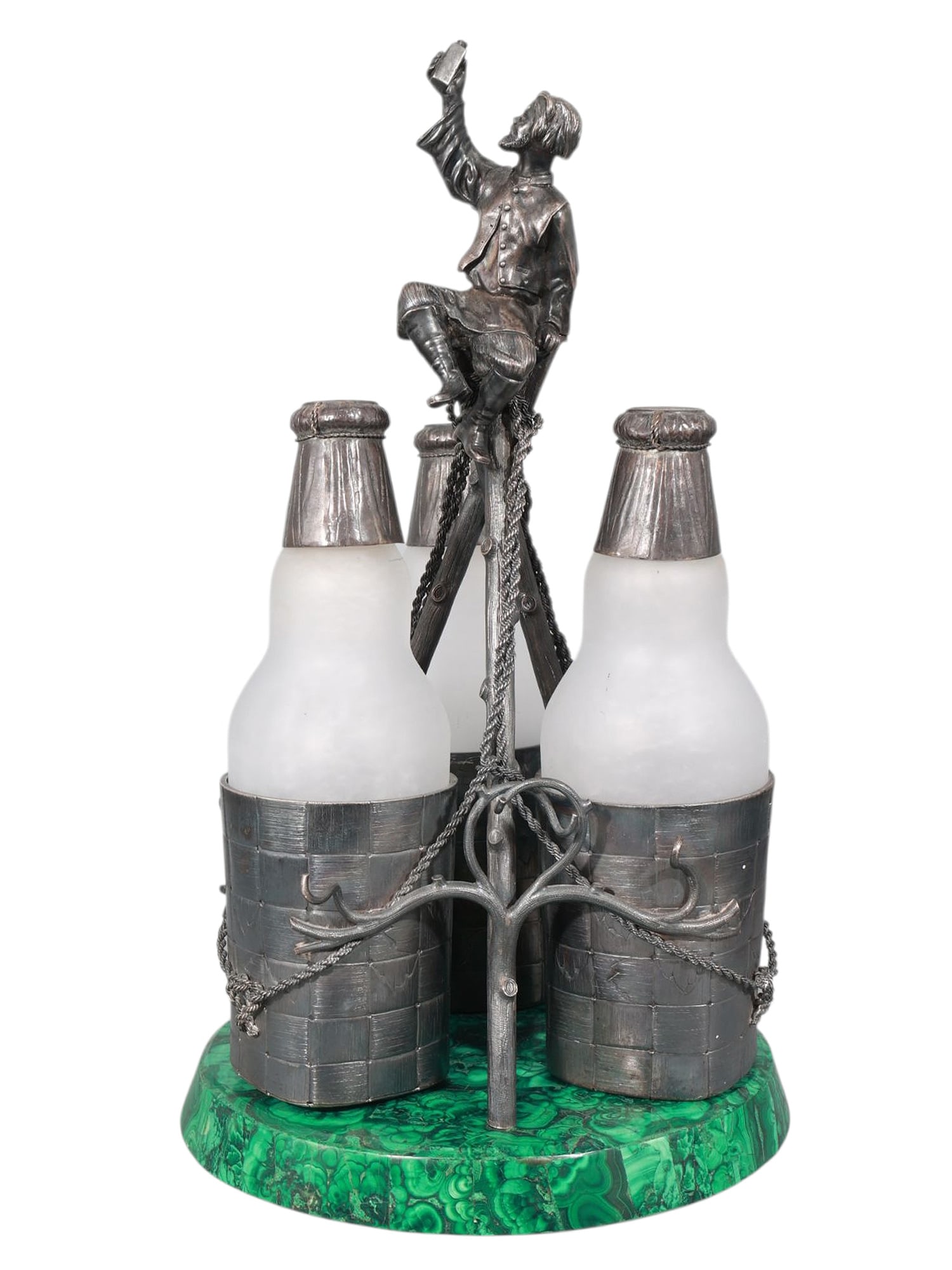 A RUSSIAN SILVER AND MALACHITE VODKA FLASK SET, 1880: Comprising three frosted glass flasks mounted in parcel-gilt and silver mounts designed to resemble wooden barrels, each bound with rope-form chains and fitted into a tripodal stand formed as stylized