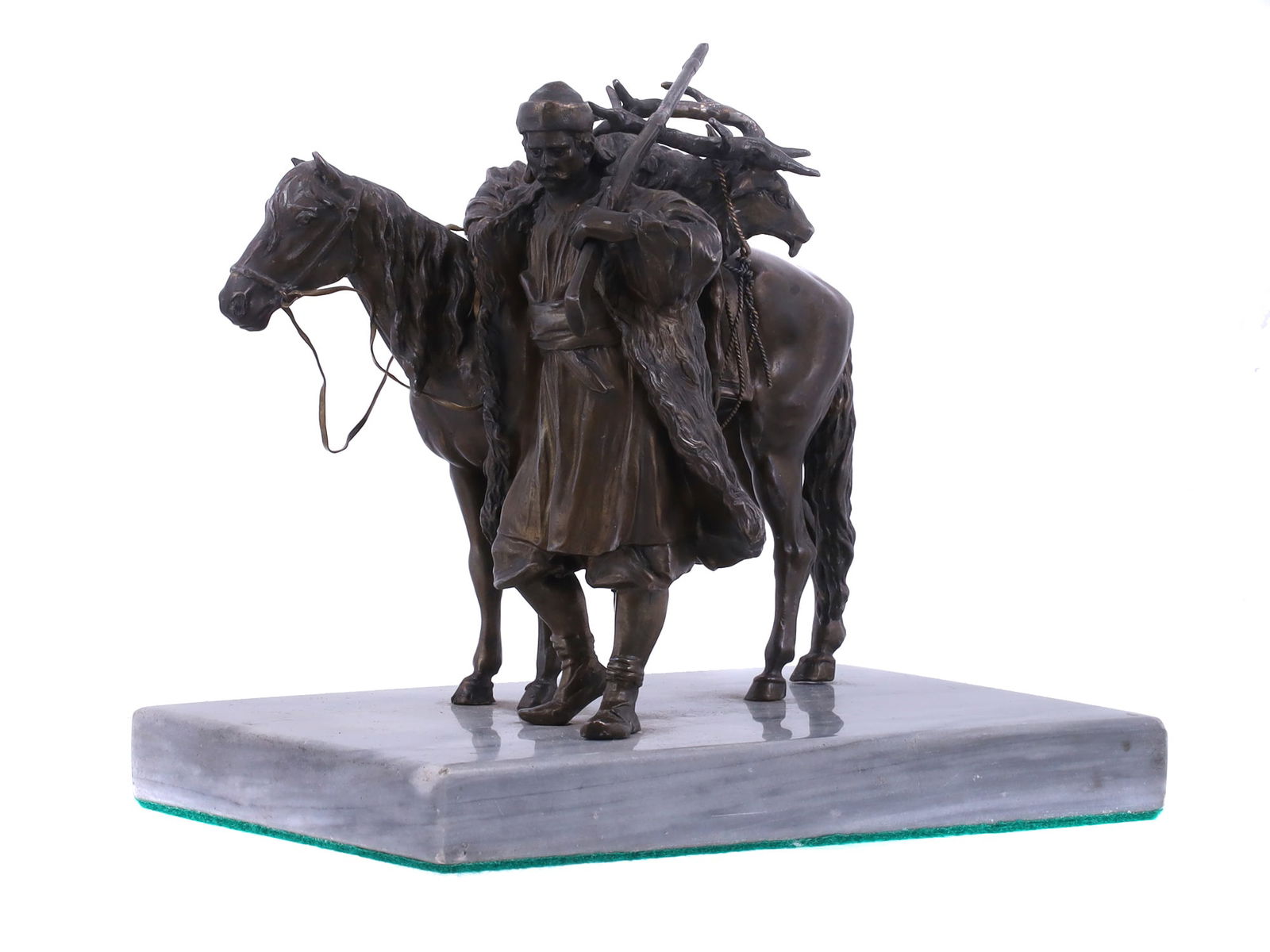 A RUSSIAN METAL GROUPING DEPICTING DISMOUNTED HUNTER 19 C.: An unusual Russian metal grouping depicting a Russian hunter with rifle standing by a horse loaded with his hunted elk; housed on polished marble base lined with green velvet. Circa 1880. Dimensions: