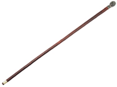 A WALKING CANE WITH HAMMERED SILVER HANDLE, 1900