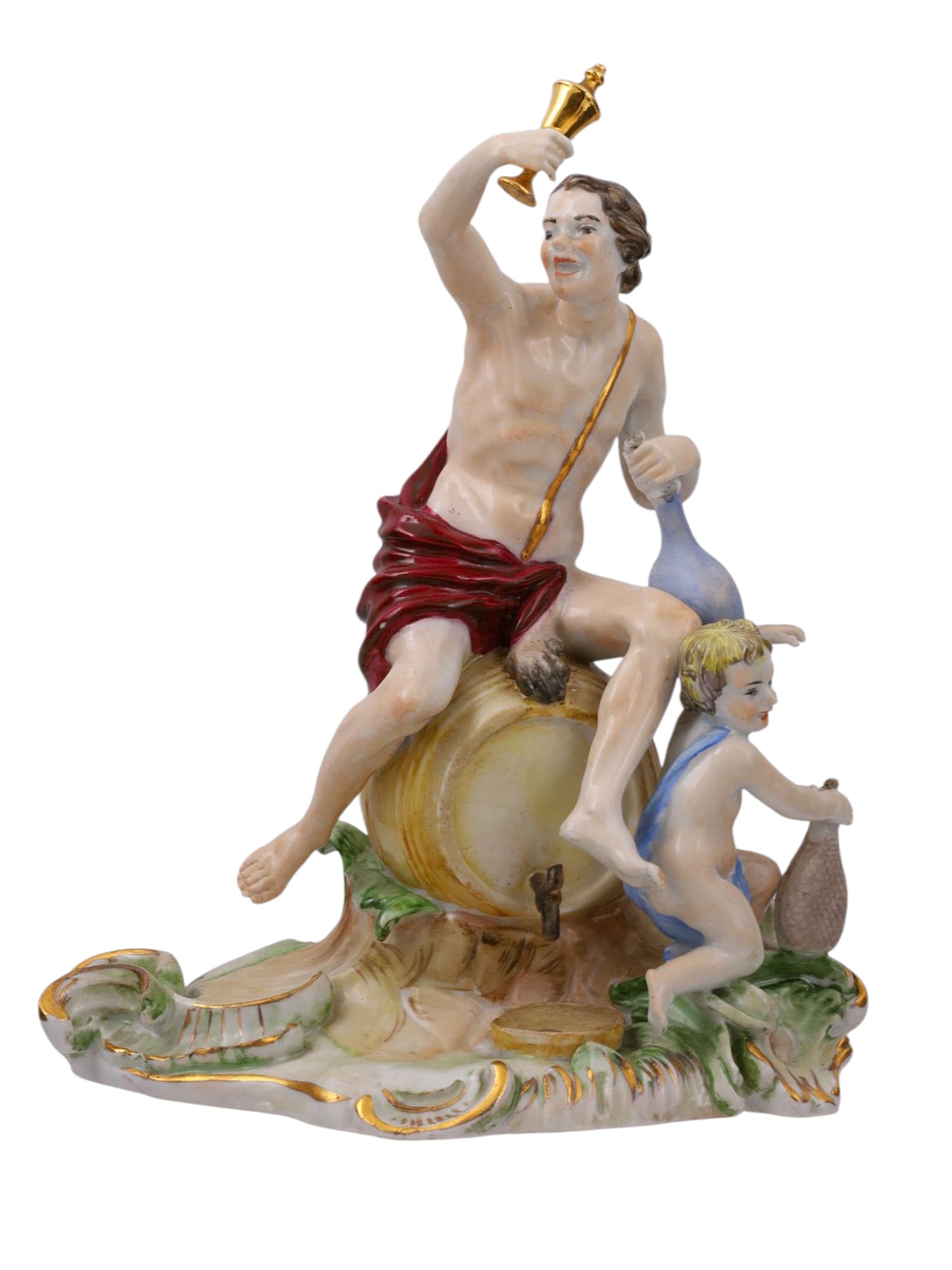 A GERMAN PORCELAIN FIGURAL GROUPING BY FURSTENBERG, 18TH C.: A GERMAN PORCELAIN FIGURAL GROUP, FÜRSTENBERG, 18TH CENTURY. A finely modeled and polychrome enameled porcelain figure group depicting Bacchus seated on a wine barrel, draped in a deep red cloak, hol