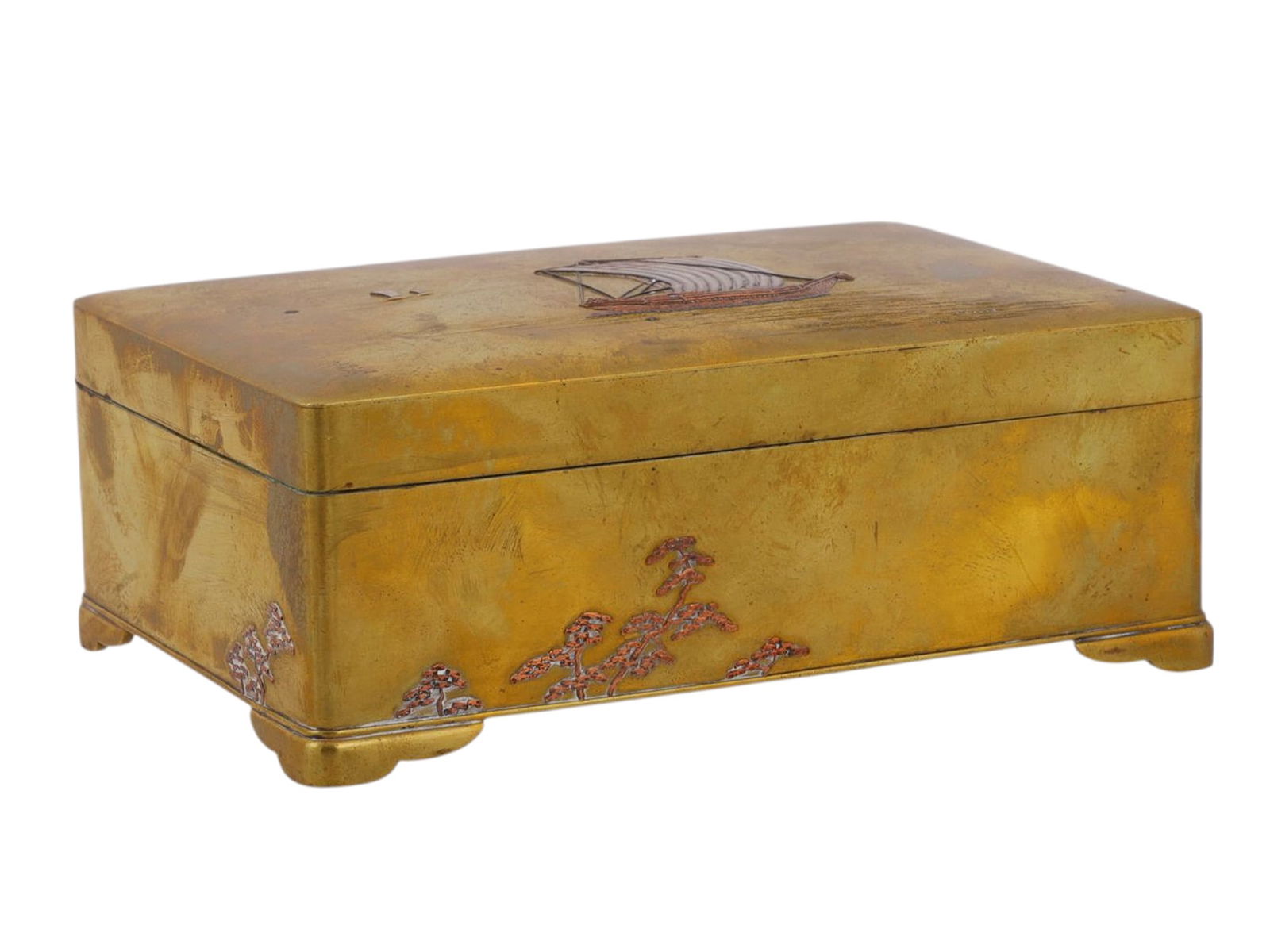 A JAPANESE MIXED-METAL LIDDED BOX, MEIJI PERIOD (1868–1912): Rectangular, raised on bracket feet, the lid decorated in relief and colored metal overlays with a sailing ship at sea, two smaller vessels in the distance, the sides with floral sprays in copper and