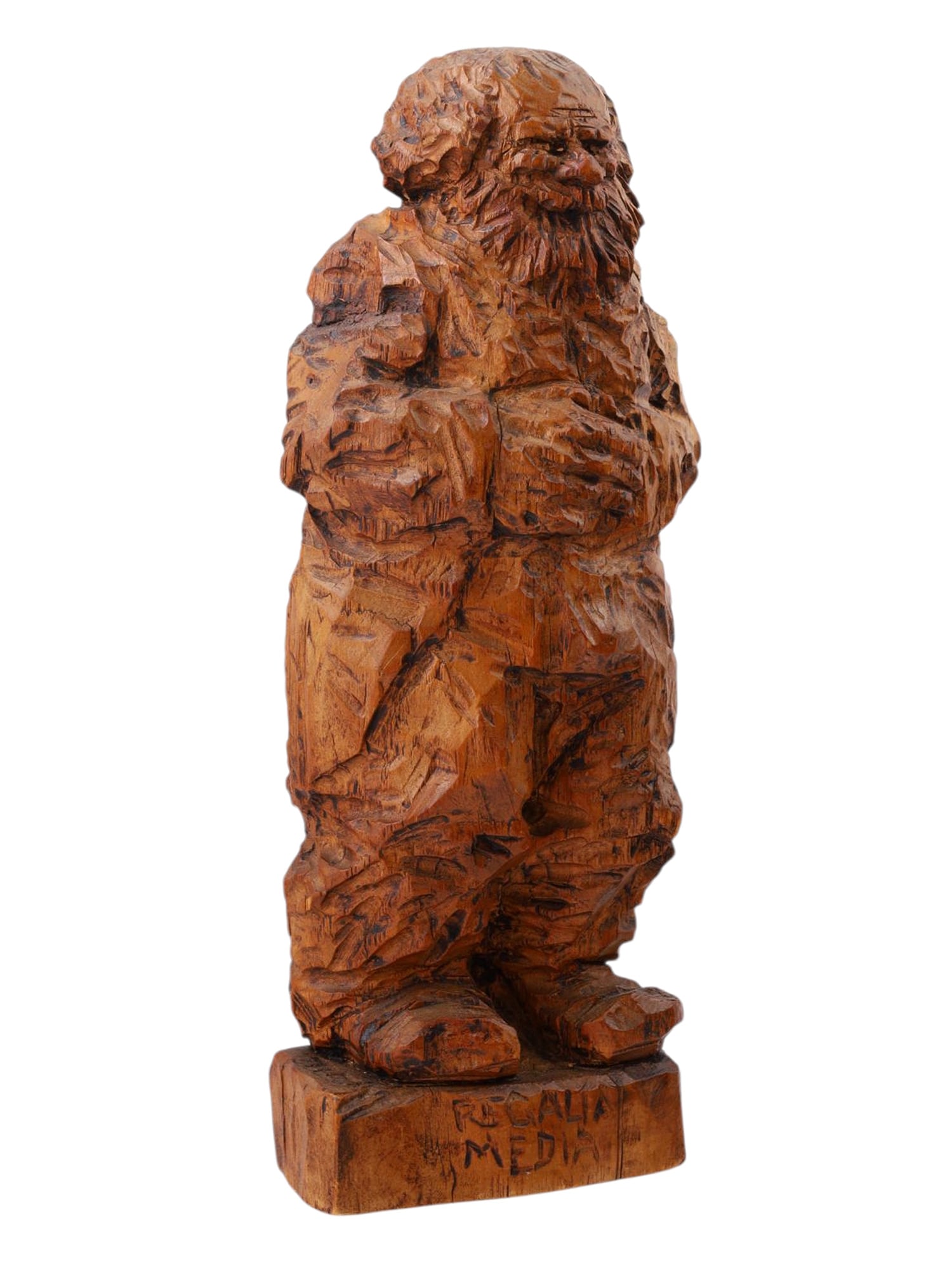 FRANZ ZELEZNY (AUSTRIAN, 1866–1932), A CARVED WOOD FIGURE "REGALIA MEDIA", EARLY 20TH CENTURY: A robust hand-carved wood sculpture by Franz Zelezny, titled Regalia Media, depicts a bearded figure with a voluminous coat and clasped hands. Executed in a heavily worked rustic style with pronounced