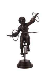 A BRONZE FIGURE OF A CLOWN ON A UNICYCLE, EARLY 20TH CENTURY