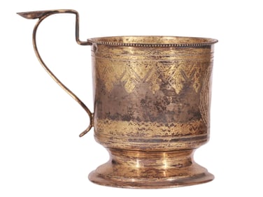 A RUSSIAN PARCEL-GILT SILVER TEA GLASS HOLDER WITH PAN-SLAVIC STYLE ETCHING