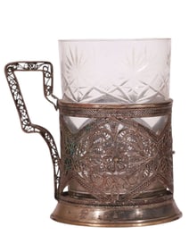 A RUSSIAN SILVER TEA GLASS HOLDER WITH OPENWORK FILIGREE DESIGN