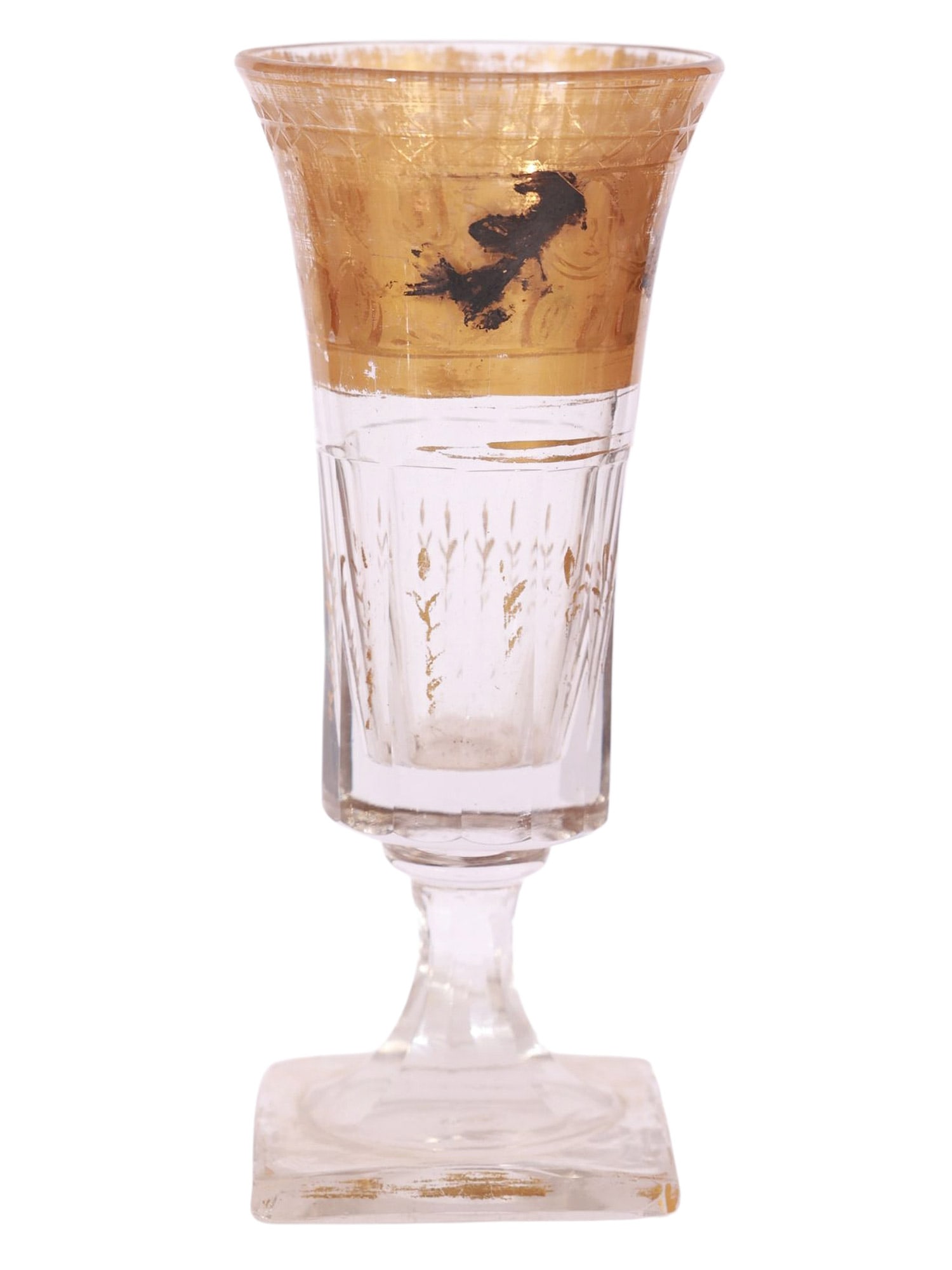 A RUSSIAN PAINTED AND GILT CUT-GLASS GOBLET, 19TH CENTURY: Of elongated, slightly flaring form, the upper register is decorated with a wide gilt band featuring leaf and scroll ornament, now worn from age and use. The body with vertically cut panels and furthe