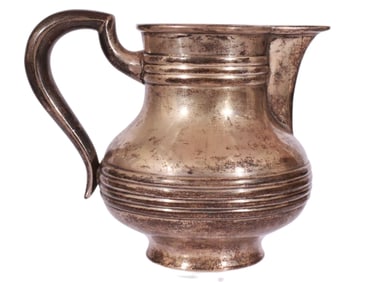 A RUSSIAN PARCEL-GILT SILVER CREAMER BY KHLEBNIKOV, LATE 19TH CEN.