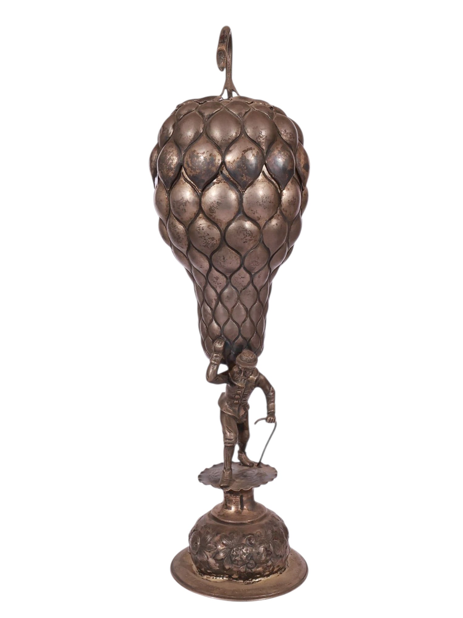 A CONTINENTAL PARCEL-GILT SILVER PINEAPPLE LIDDED GOBLET: A finely modelled and richly detailed silver goblet of imaginative pineapple form, the body composed of overlapping lobes, the interior gilded. The removable lid surmounted by a curled hook finial, th
