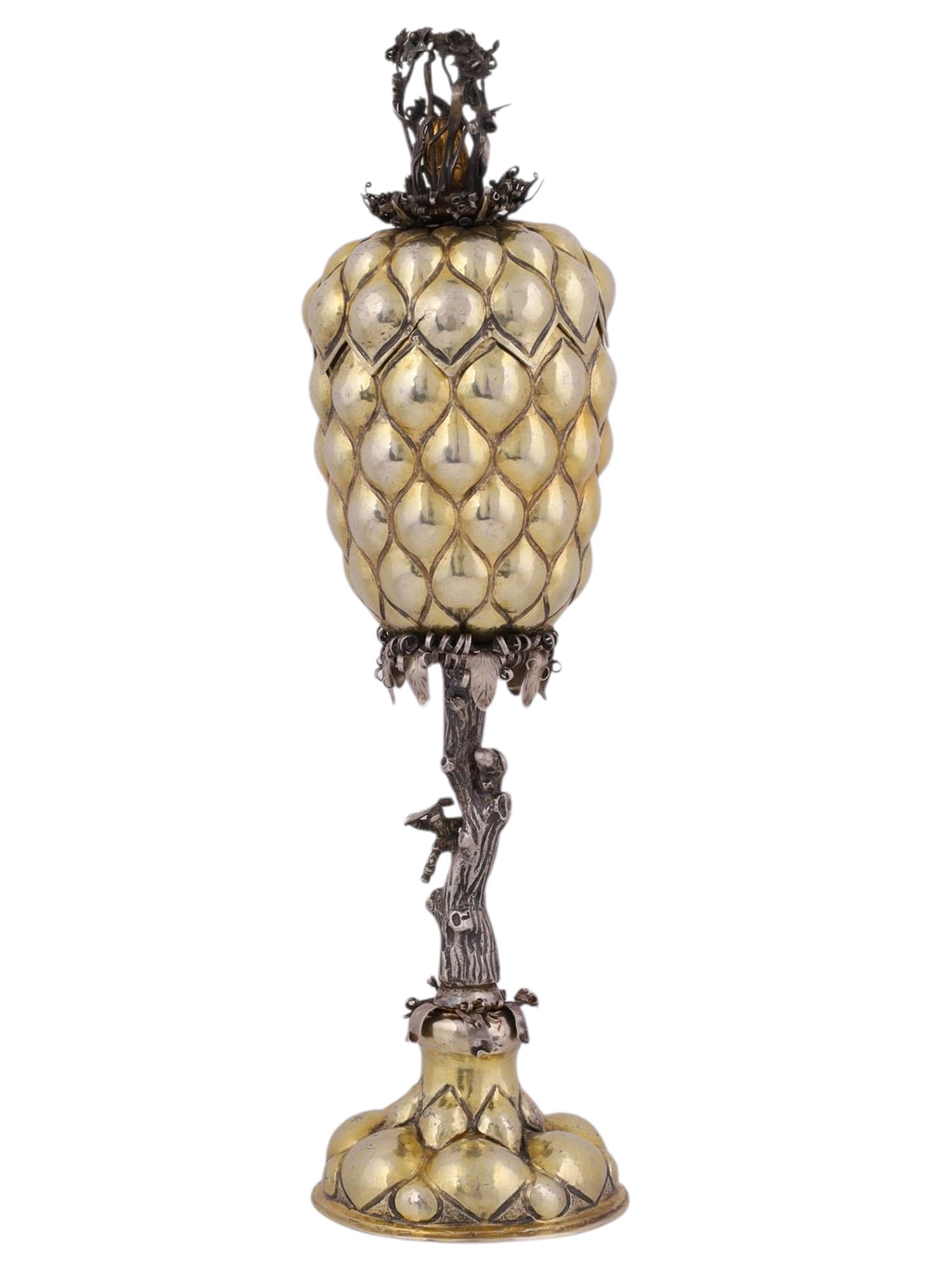 A RUSSIAN PARCEL-GILT SILVER LIDDED GOBLET IN THE FORM OF A PINEAPPLE, MOSCOW, 1795: The goblet formed as a stylized pineapple, the lobed and parcel-gilt body richly chased and repoussé with overlapping scale motifs. The detachable cover surmounted by an elaborate foliate finial, fin