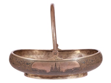A LARGE RUSSIAN PARCEL-GILT SILVER AND NIELLO BASKET WITH A VIEW OF MOSCOW KREMLIN, 1894