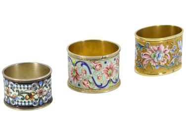 A SET OF 3 RUSSIAN GILT SILVER AND ENAMEL NAPKIN RINGS