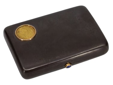 A RUSSIAN GUN METAL CIGARETTE CASE HOLDER MOUNTED WITH A GOLD COIN