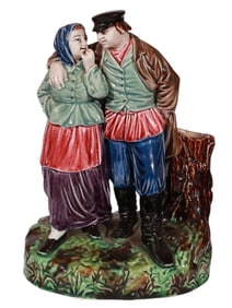 A KUZNETSOV HAND-PAINTED PORCELAIN FIGURINE OF A PEASANT COUPLE