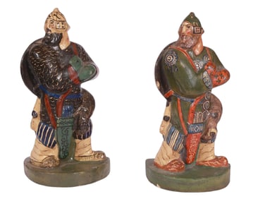 A PAIR OF RUSSIAN POLYCHROME CERAMIC BOOKENDS AS BOGATYRS