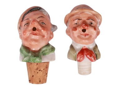 A PAIR OF PORCELAIN FIGURAL CORK TOPPERS