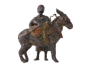 A METAL HAND-PAINTED FIGURE OF A DONKEY AND A BOY
