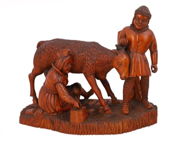 AN EARLY 20TH-CENTURY HAND-CARVED WOODEN GROUP FIGURE OF A SHEPHERD WITH A GOAT