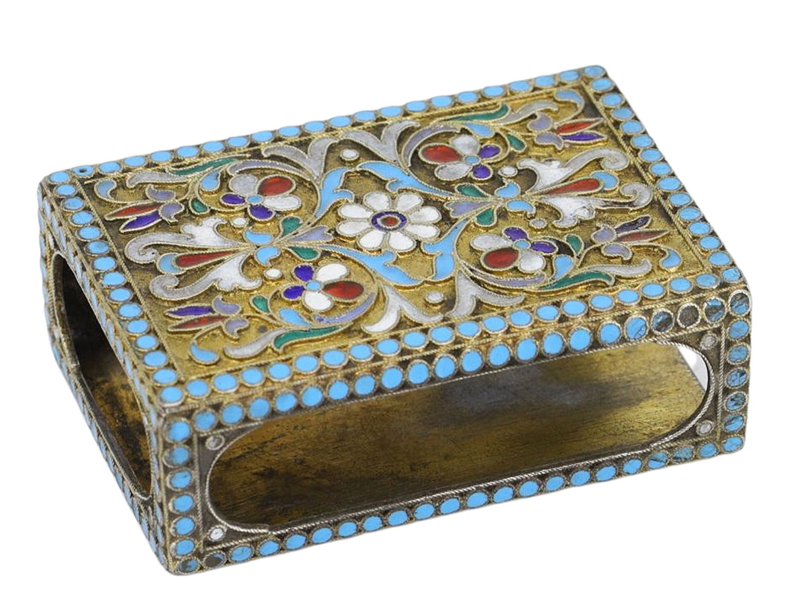 A RUSSIAN SILVER AND CLOISONNE ENAMEL MATCHBOX HOLDER, C. 1910: A Russian silver matchbox holder decorated across its surface with intricate cloisonne enamel in polychrome floral patterns against a gilt ground. These matchbox holders would have been used by wealth