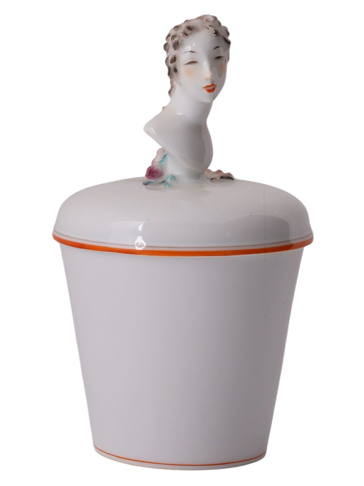 A MEISSEN PORCELAIN LIDDED JAR WITH FEMALE BUST FINIAL BY PAUL SCHEURICH, GERMANY, CIRCA 1937–1945: White glazed porcelain lidded cosmetic or powder jar of tapering cylindrical form with a domed cover surmounted by a stylized female bust finial executed in the mature sculptural language of Paul Sche