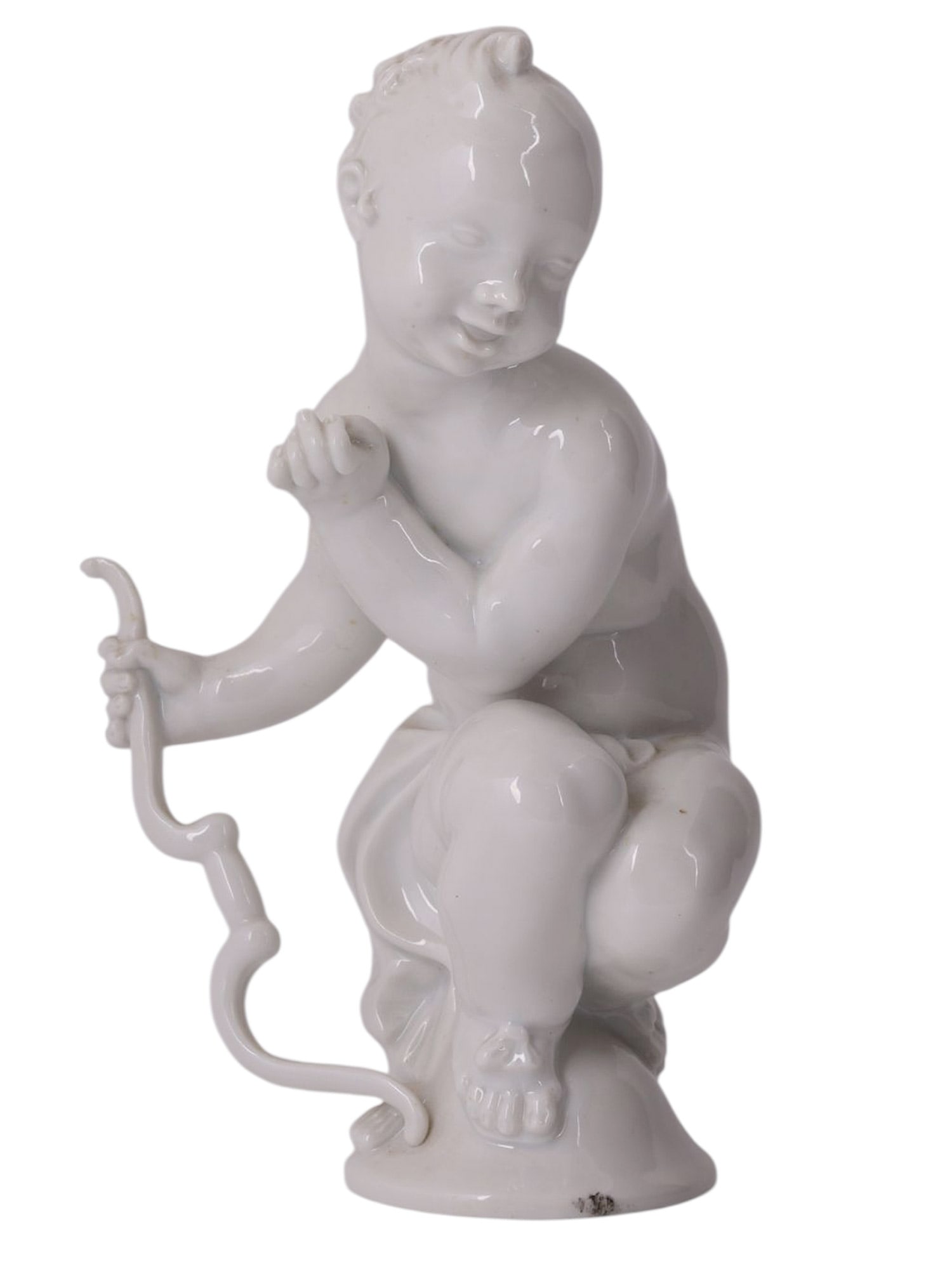 A MEISSEN WHITE PORCELAIN FIGURE OF A PUTTO OR AMOR BY PAUL SCHEURICH, GERMANY, CIRCA 1910-1924: A finely modeled white-glazed porcelain figure depicting a seated putto or Amor shown nude and holding a stylized bow. The figure is rendered with soft rounded anatomy and sensitively modeled facial f