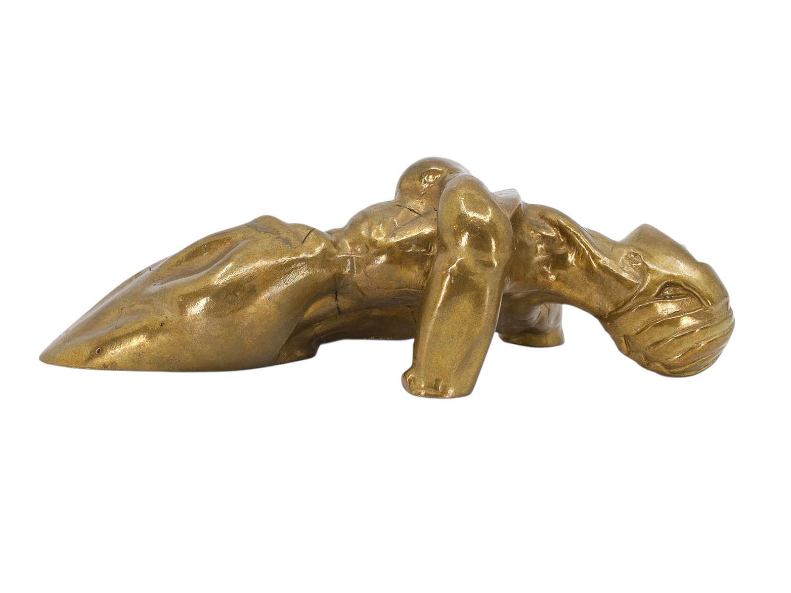 A BRONZE NUDE PAPERWEIGHT, AUSTRIA, CA. 1930: A stylized cast bronze paperweight in the form of a reclining nude female figure, executed in a bold, expressive manner characteristic of early 20th-century Austrian decorative bronze work. The figure
