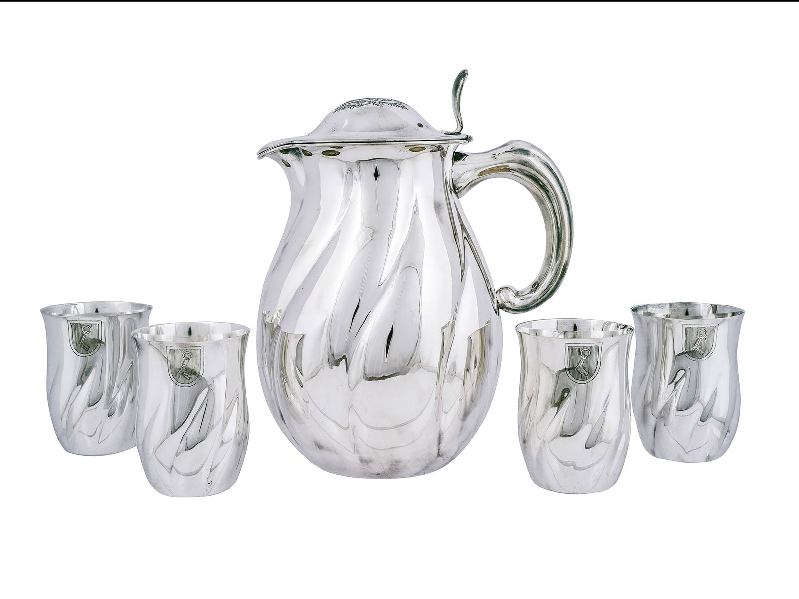 A RARE NAZI GERMAN SILVER SET OF FOUR HERMANN GÖRING COAT OF ARMS GOBLETS AND A PITCHER, CIRCA: A historically significant five-piece silver drinking service comprising a bulbous, hand-raised silver pitcher with a hinged lid and four matching goblets. Part of a larger service, with other items f
