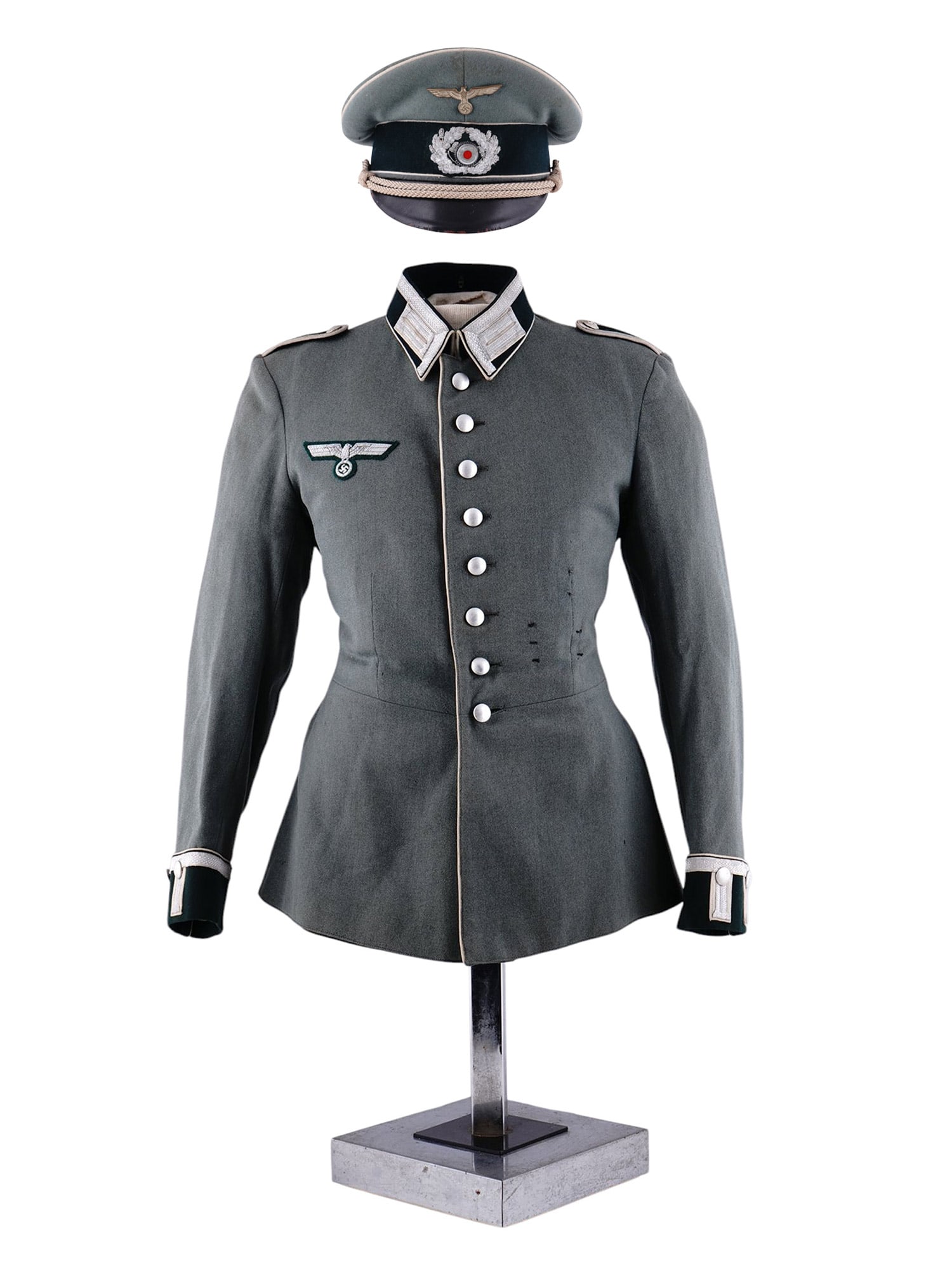 A GERMAN WEHRMACHT ARMY OBERLEUTNANT DRESS TUNIC AND VISOR CAP: A German Wehrmacht Heer (Army) officer’s parade or dress tunic and visor cap, used during World War II, likely by a Leutnant or Oberleutnant (2nd or 1st Lieutenant) based on the insignia. Tunic (Waf