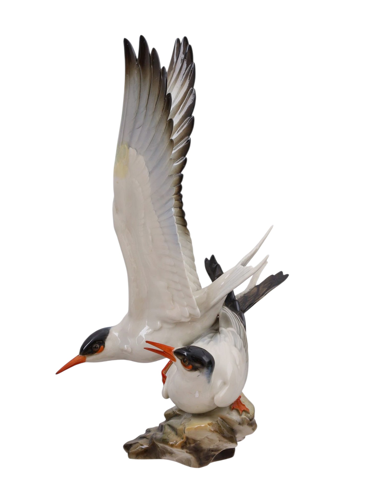 A HUTSCHENREUTHER PORCELAIN FIGURAL GROUP OF SEAGULLS, DESIGNED BY G. GRANGÉ, GERMANY, 20TH CENTURY: Modeled in fine white porcelain, the naturalistic group depicts two seagulls upon a rocky base, one perched and alert while the other spreads its wings in flight. The birds are finely hand-painted wit