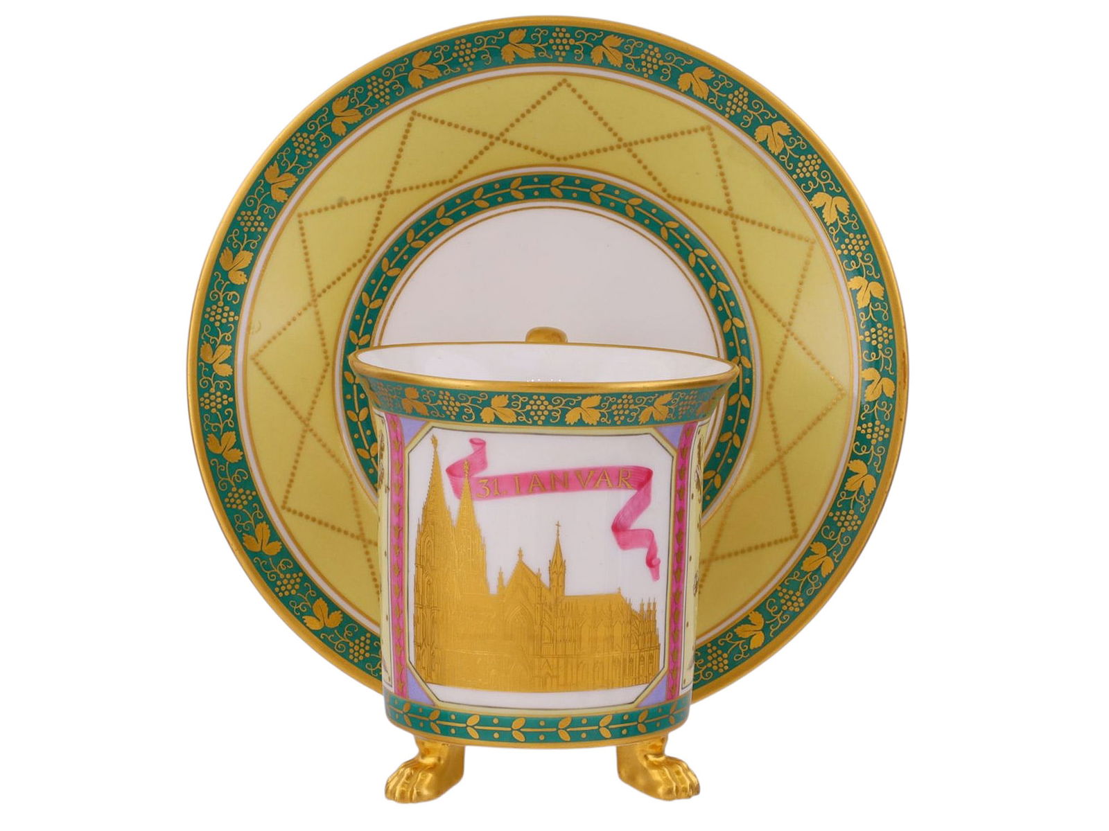 A KPM PORCELAIN MATCHING CUP AND SAUCER, 19TH CENTURY: Fine hard-paste porcelain cup and saucer manufactured by the Königliche Porzellan-Manufaktur Berlin (KPM), late 19th century. The cylindrical cup raised on three molded gilt paw feet, fitted with a s