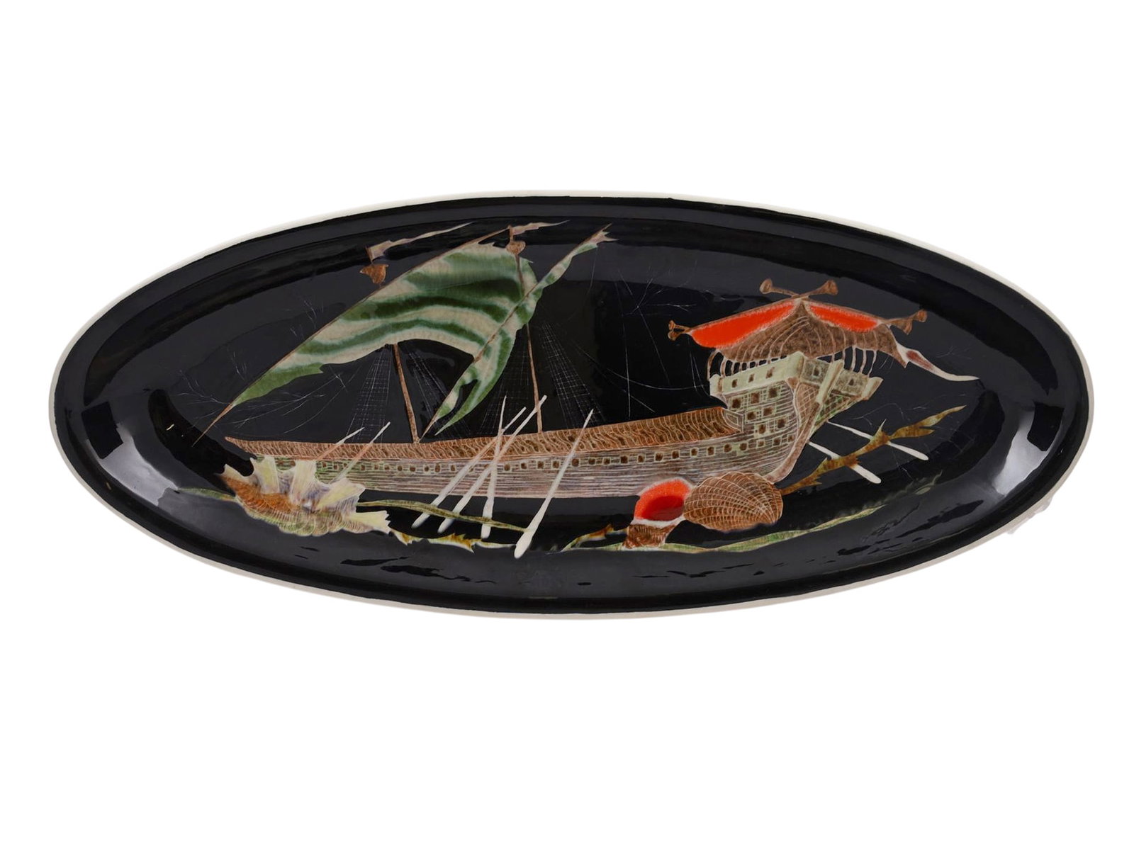 GUY TRÉVOUX (FRENCH, 20TH CENTURY), A QUIMPER PORCELAIN CHINOISERIE PLATE: Of elongated oval form, decorated against a black ground with a fantastical galleon incorporating stylized oriental pagoda structures and sails, flanked by seashell motifs. The reverse is signed Guy T