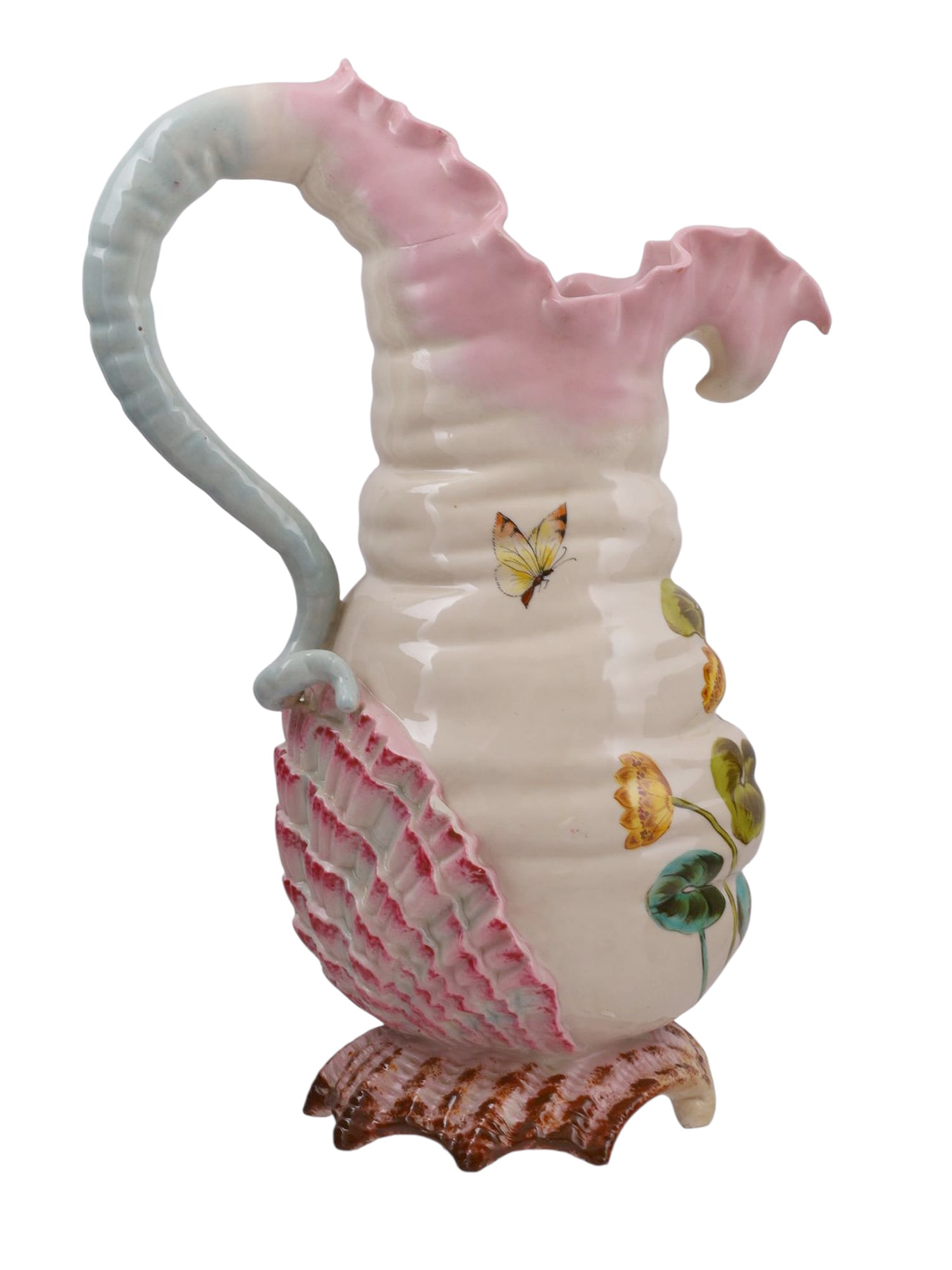 A RUDOLSTADT ART NOUVEAU HAND-PAINTED POTTERY PITCHER, LATE 19TH / EARLY 20TH CENTURY: Of naturalistic shell and marine form, the pitcher is modeled with a scallop shell foot supporting a body with molded ridges and ruffled lip, the handle formed as a curling sea form. The body is decor