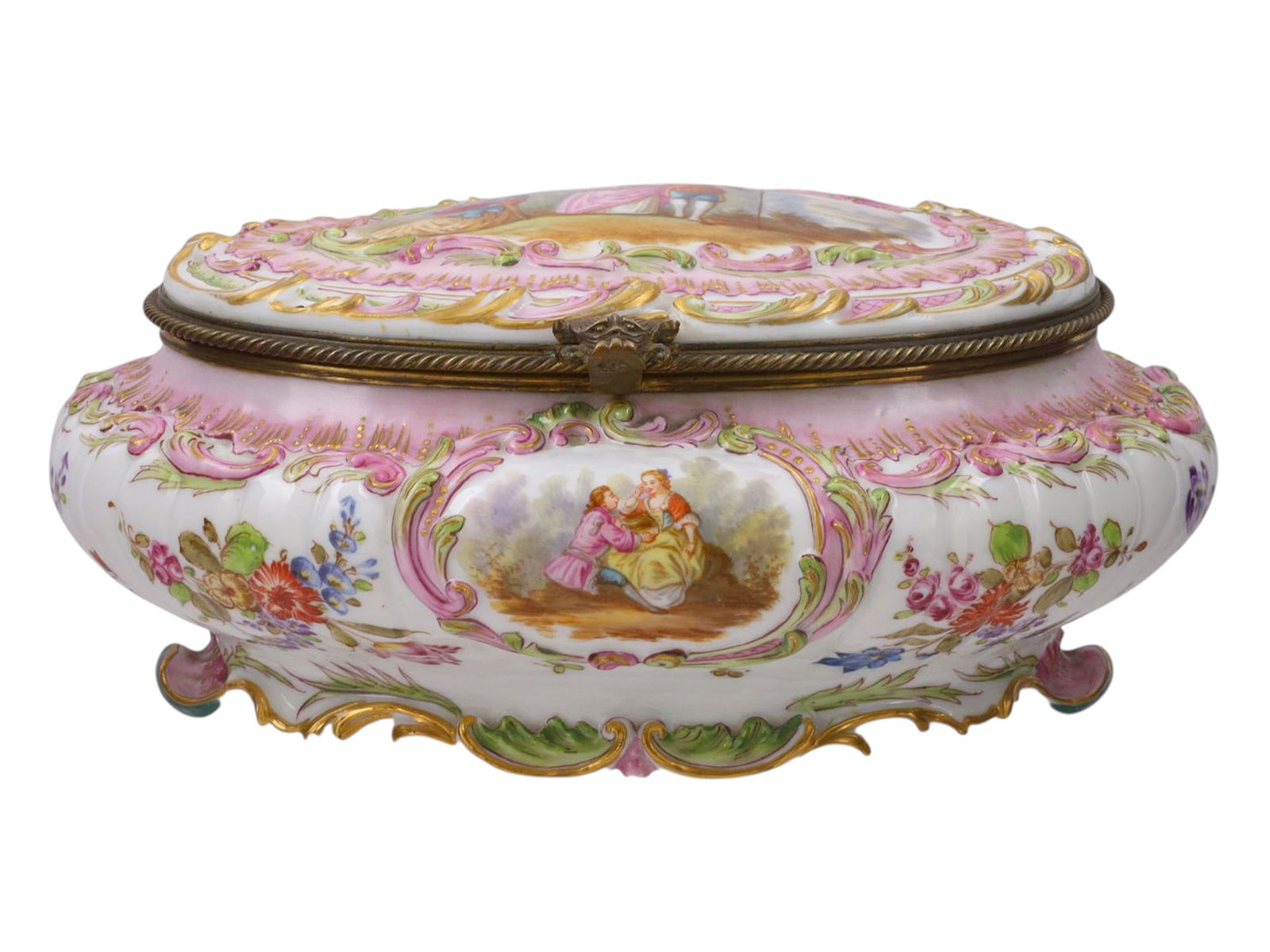 A BRASS-MOUNTED DRESDEN PORCELAIN BOX: Of large oval form, finely hand-painted with panels of romantic courting couples and landscapes within scrolling gilt rococo cartouches, all surrounded by abundant floral sprays on a white and pink gr