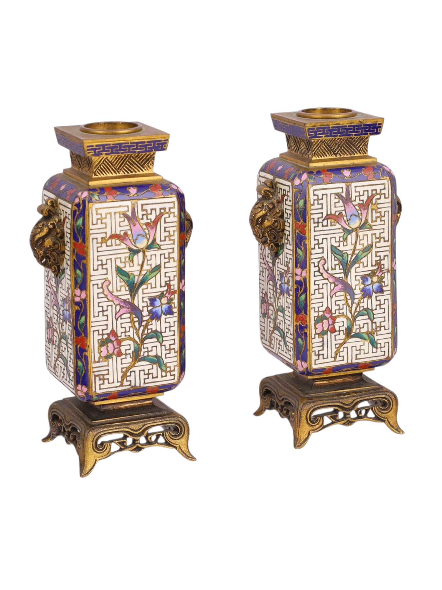A PAIR OF CHINESE CLOISONNÉ ENAMEL VASES ON GILT BRONZE STANDS, LATE QING DYNASTY: Each of the square sections with a tapering body, decorated in vibrant polychrome enamels against a white ground with floral sprays and scrolling foliage, framed within borders of stylized key-fret an