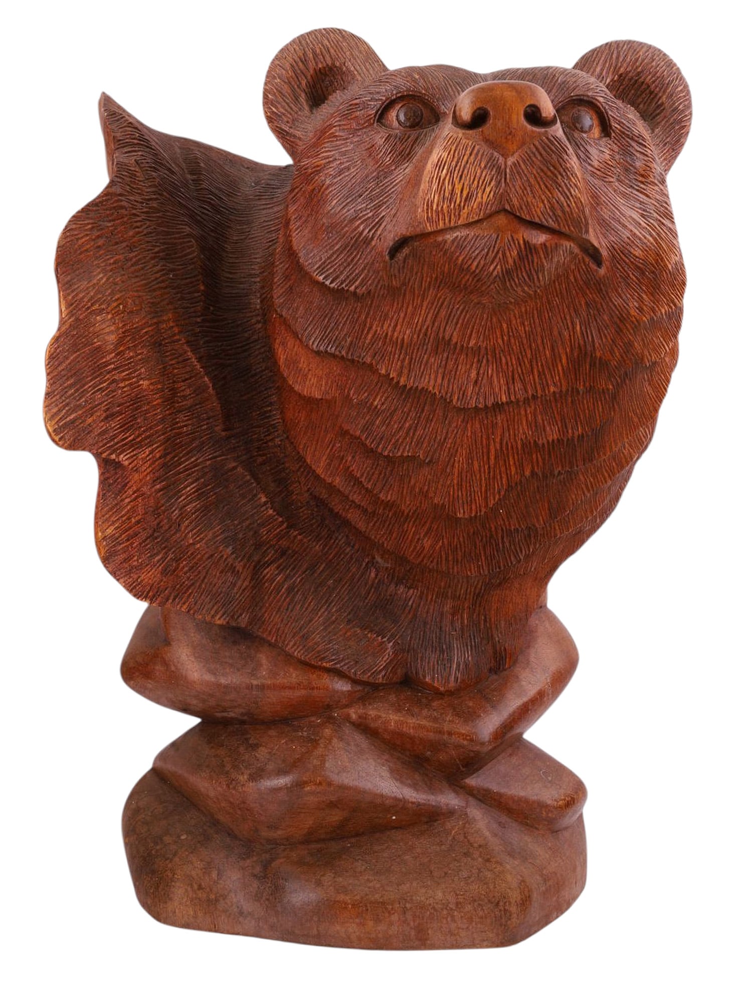 A LARGE BLACK FOREST CARVED BEAR BUST, EARLY TO MID 20TH CENTURY: A finely carved Black Forest wooden sculpture of a bear gazing curiously toward the viewer, every hair on its body delicately rendered for a realistic effect. The base is carved to appear like stacked
