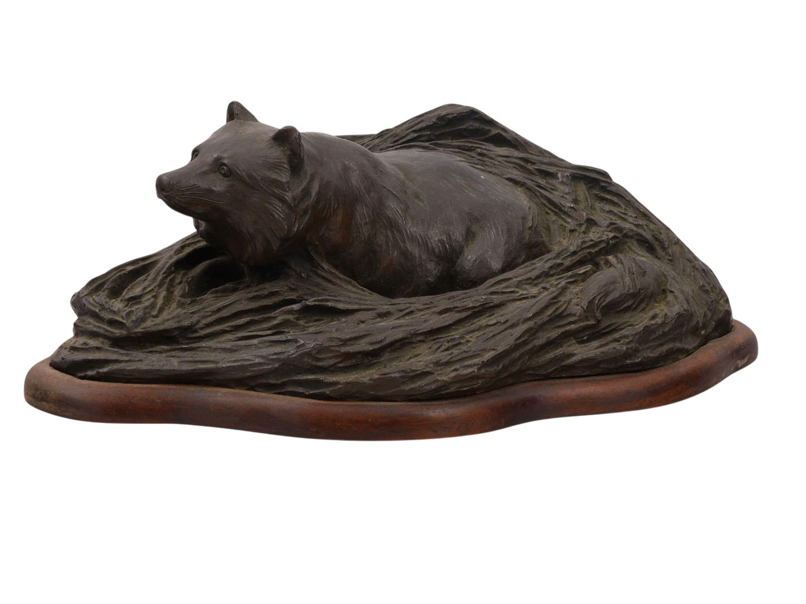 A SIGNED JAPANESE BRONZE OF A FOX IN ITS DEN, MEIJI PERIOD: Finely cast bronze group depicting a fox reclining within a rocky hollow, the animal’s alert expression and fur details rendered with naturalistic modeling. The den is sculpted as rugged rockwork, t