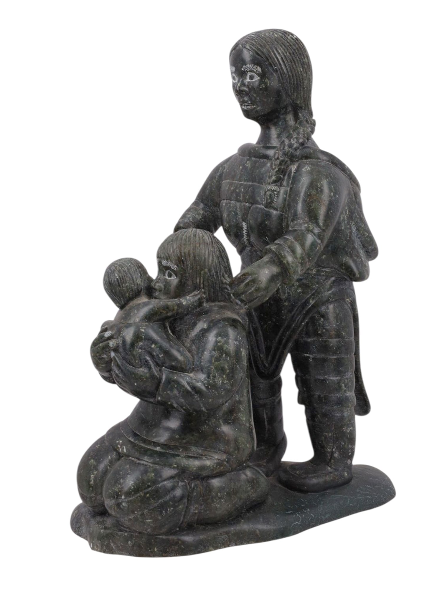 AN INUIT SOAPSTONE FIGURAL GROUPING, 1992: An Inuit figural sculpture carved from soapstone, showing two adults, with one kneeling on the ground holding an infant child. The underside is inscribed with what appears to be a model or inventory n
